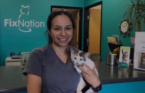 A woman holding a cat